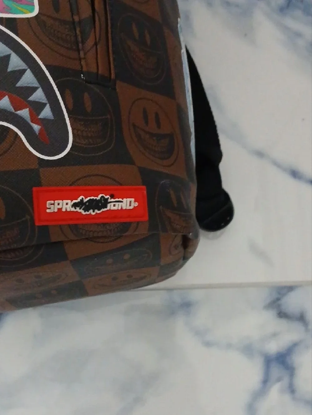 Sprayground Brown Checkerboard Backpack with Multicolor Sticker Graphics